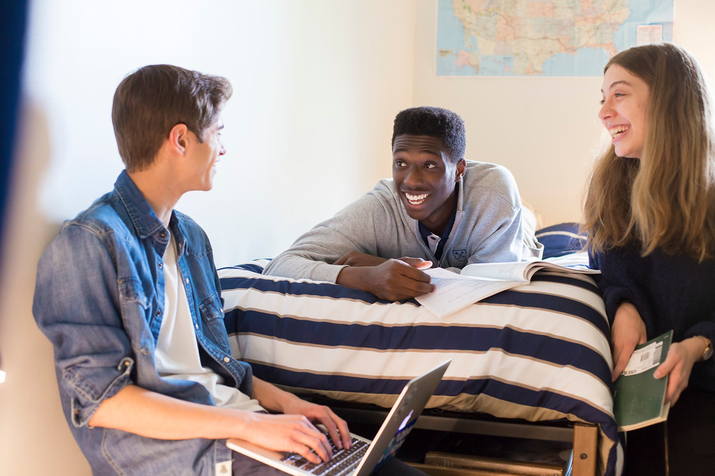 Three students working on homework together in a dorm room at Emory University's Oxford Campus. 