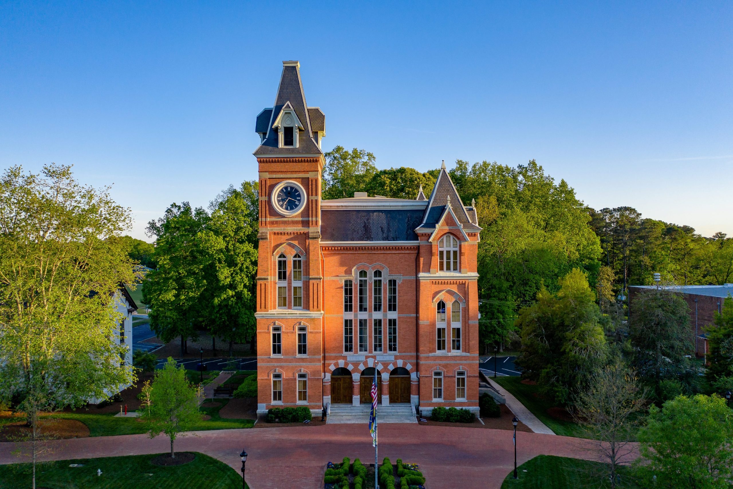 Seney Hall surrounded by green trees