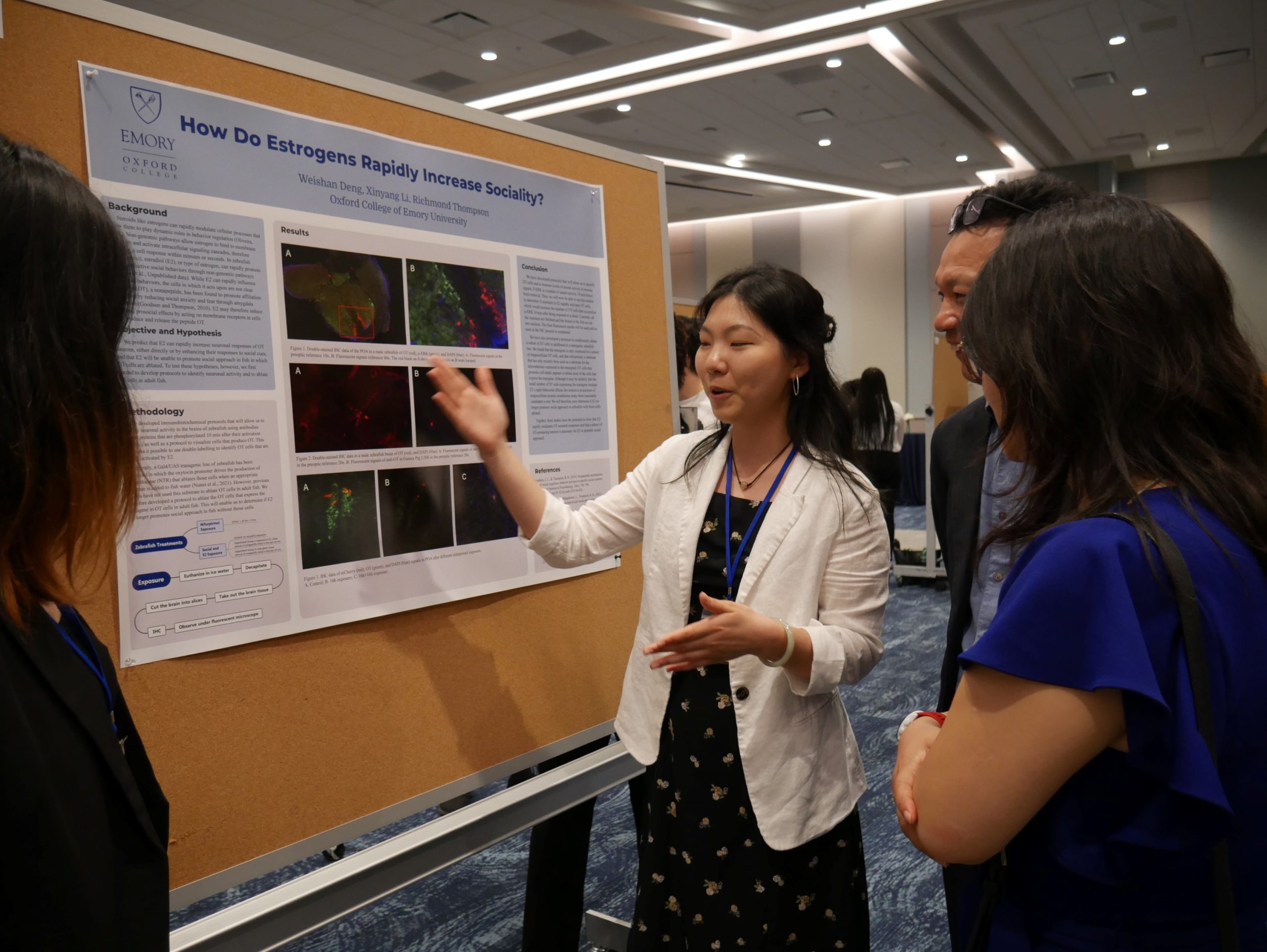 Female student pointing to research presentation